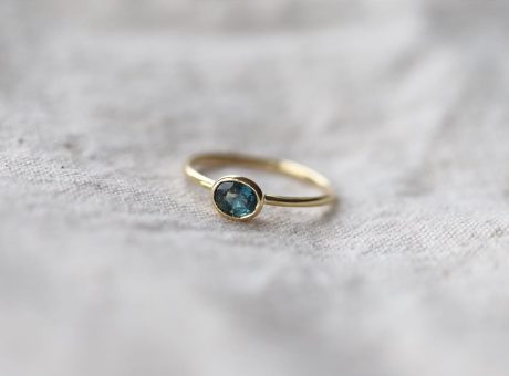 a gold ring with a blue stone